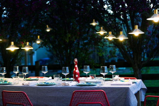 Elegant outdoor table set for a party with outdoor string lights with metal shades by Color Cord